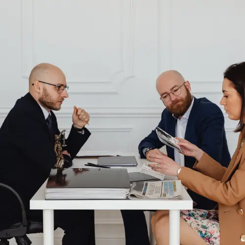 Lawyer reviewing documents with clients during a legal consultation