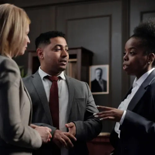 Professionals discussing legal options in a formal office setting